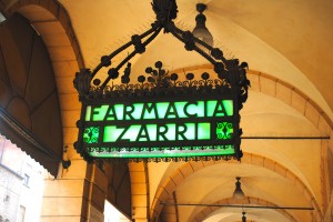 Farmacia sign under portico in Bologna