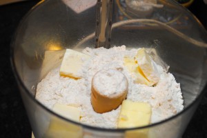 Mix flour, sugar, salt and butter in food processor.