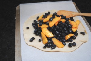 Peaches and blueberries on pastry dough